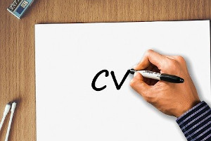 Hand writing "CV" on a blank piece of paper