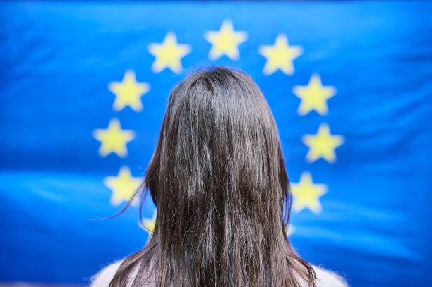 Woman in front of the EU flag